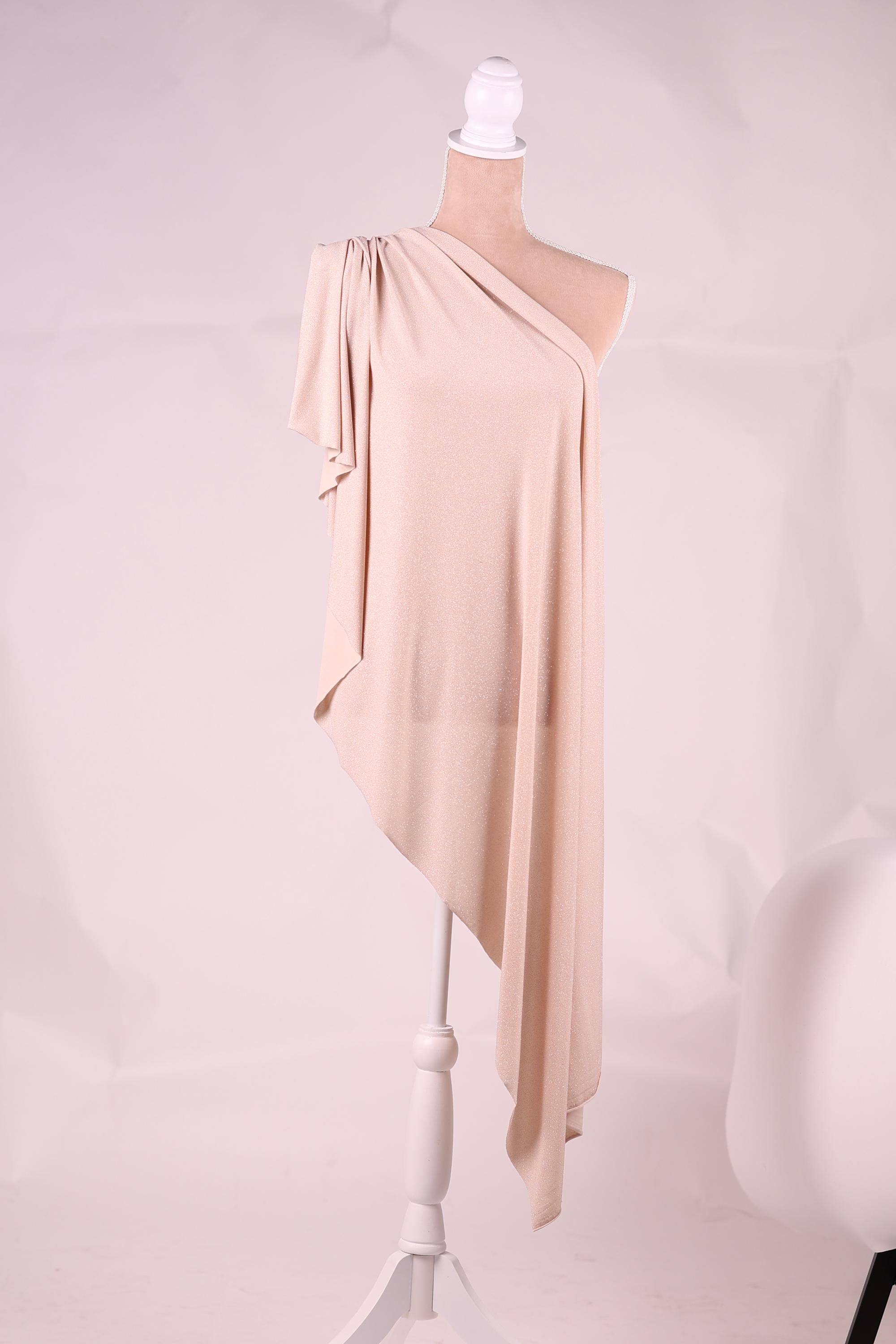 A pink fabric is draped over a white pole, creating a visually striking contrast.