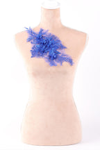 A mannequin with a floral design on its bust, featuring blue flowers and leaves.