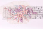 a close-up view of a delicate floral embroidery with pink and purple flowers, leaves, and pearls. The embroidery appears to be crafted with precision and care, showcasing the intricate details of the design.