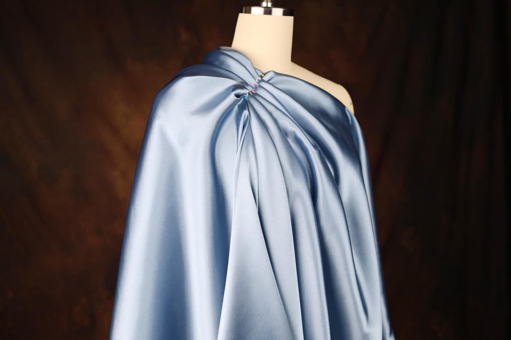 a dress on a mannequin with a blue cape