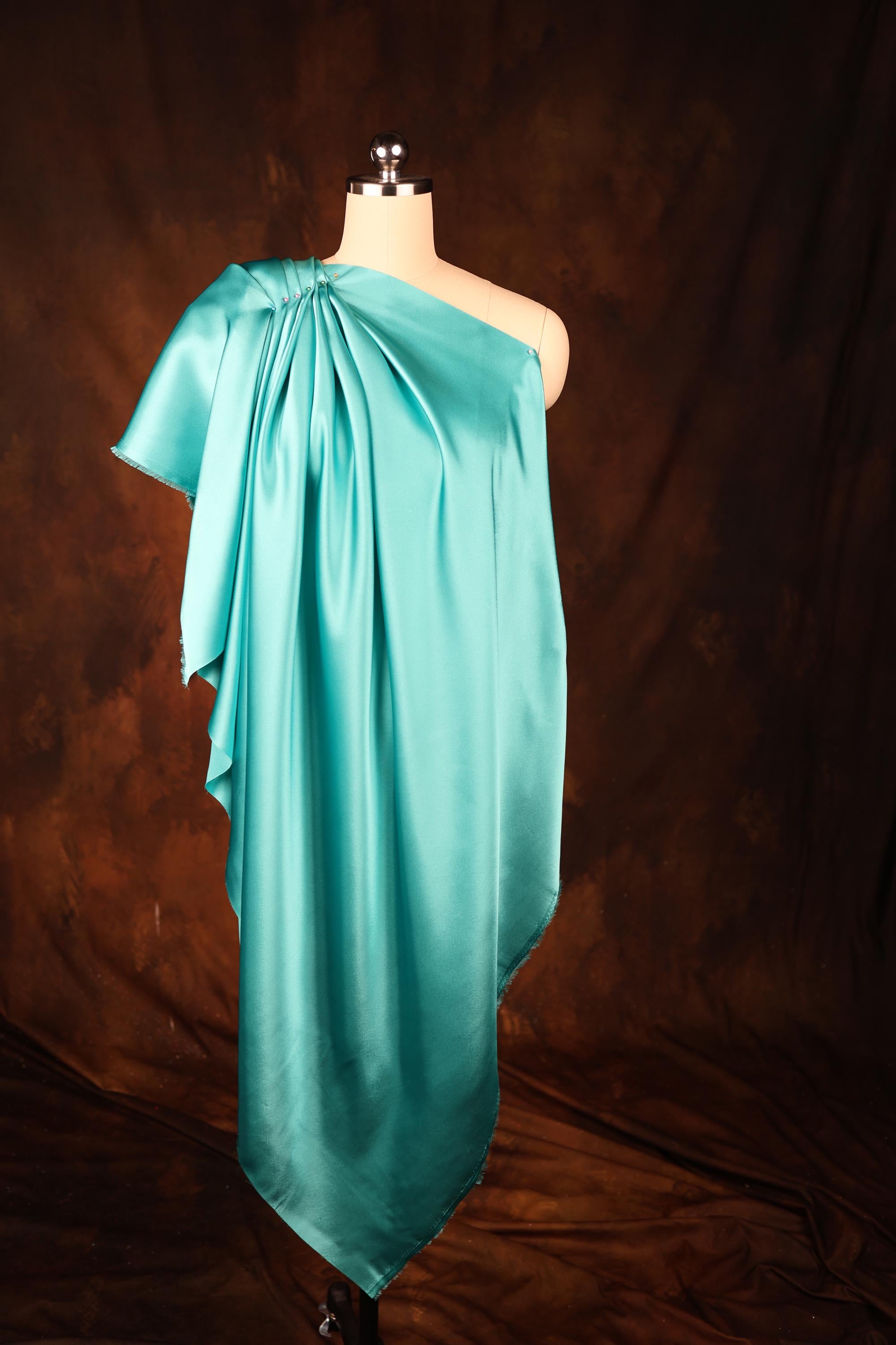 a dress on a mannequin with a brown background