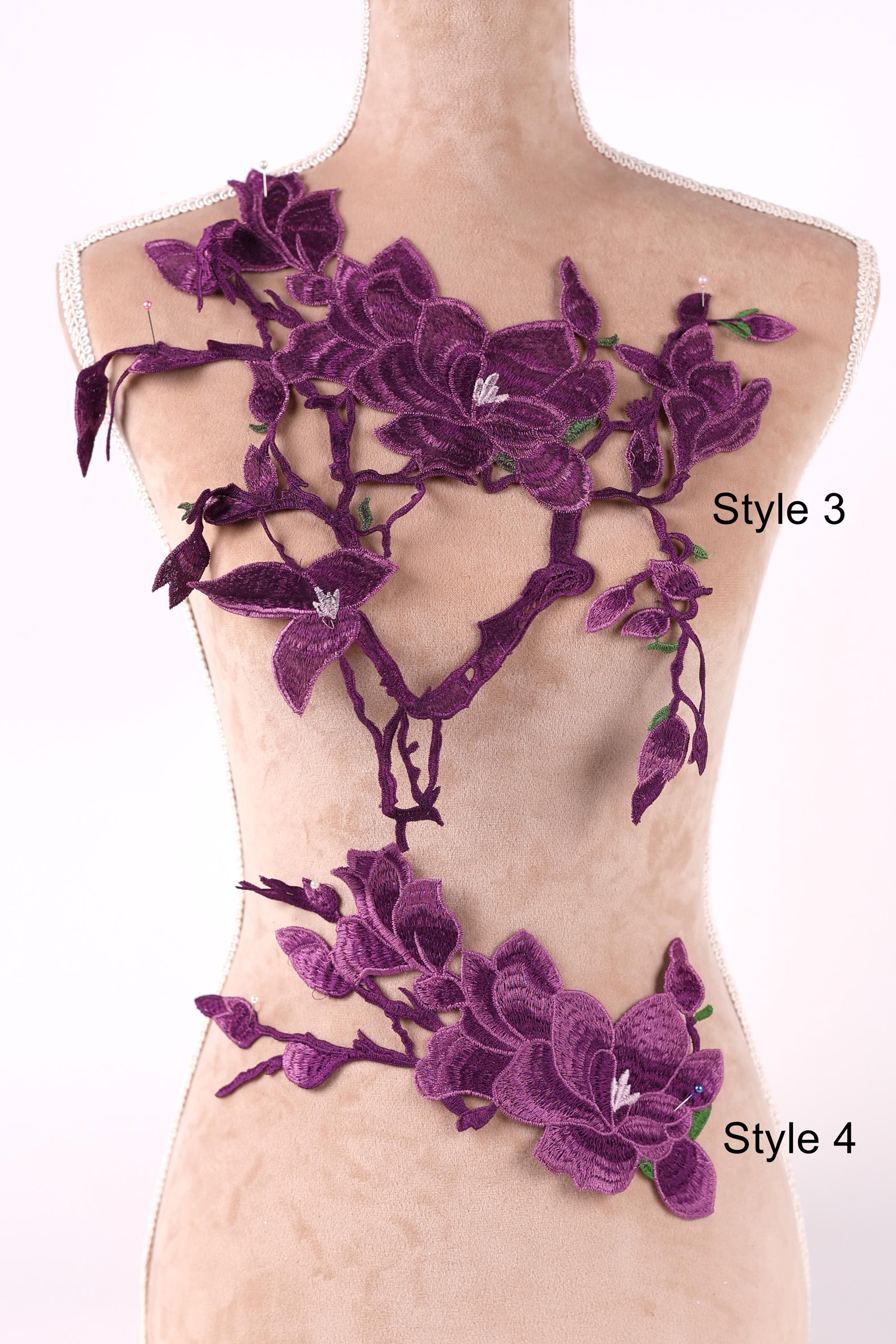 A mannequin wearing a dress with purple floral embroidery on the bust and hips.