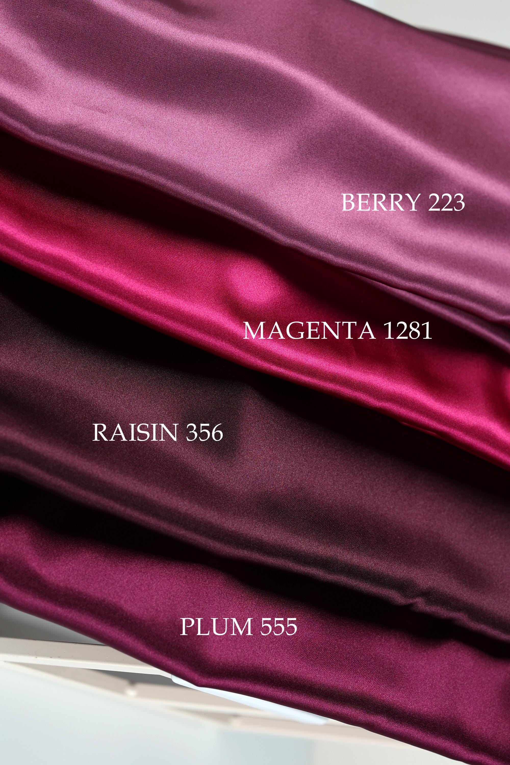 a close-up view of three different colored satin fabrics, each labeled with a color name.