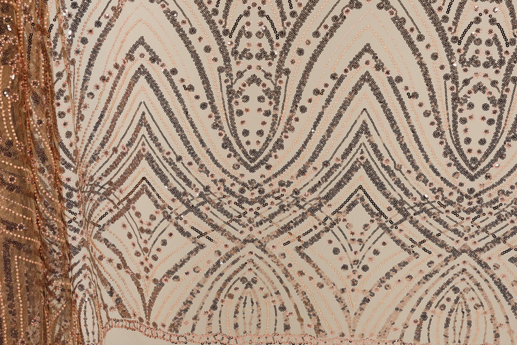 a close-up view of a fabric with a repeating pattern of diamond shapes and small dots in shades of brown and beige. The pattern is intricate and visually striking, with the diamonds and dots creating a sense of depth and texture.