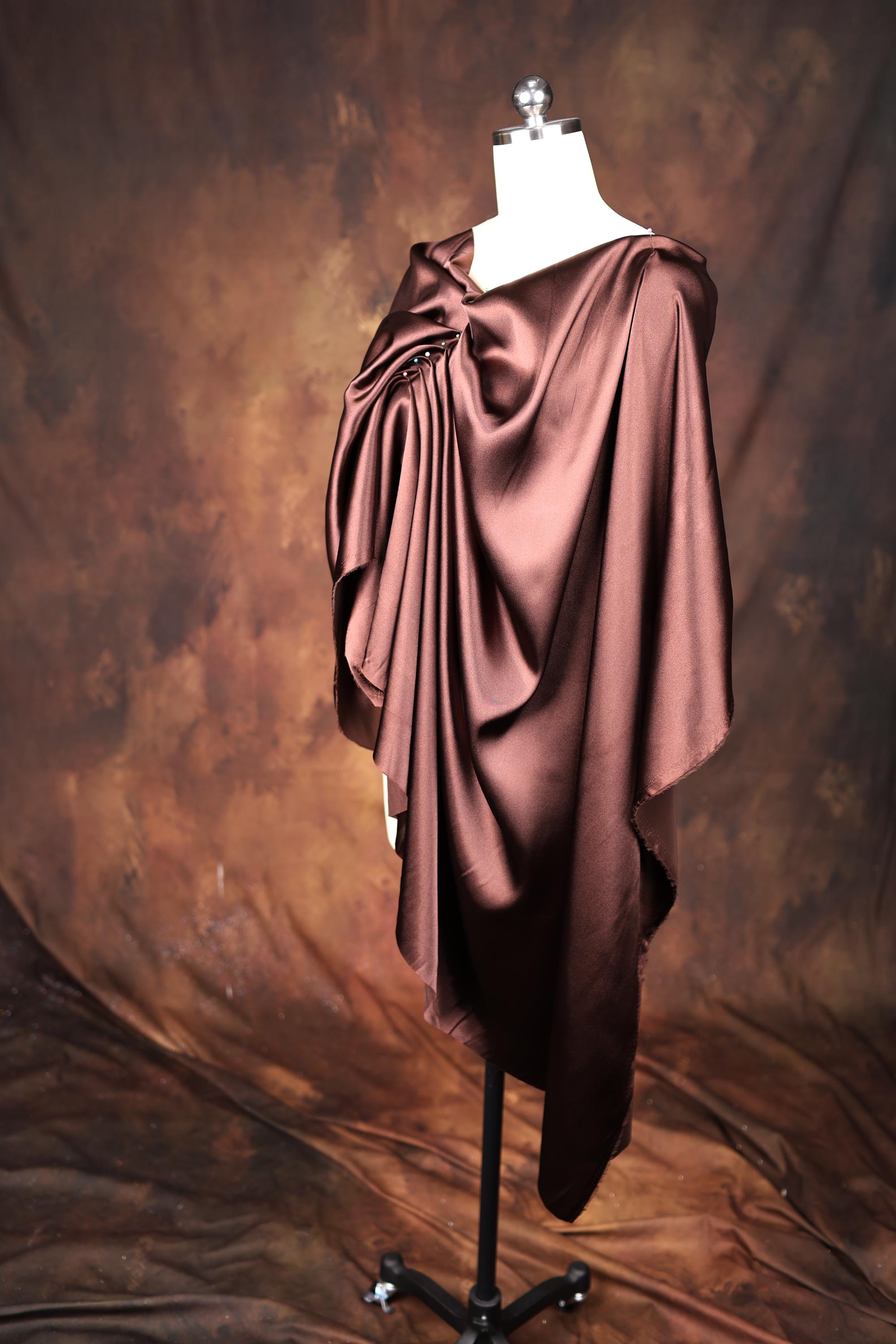 a dress on a mannequin with a brown background
