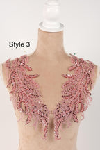 A mannequin wearing a pink sequin and lace bodice with a decorative floral pattern.