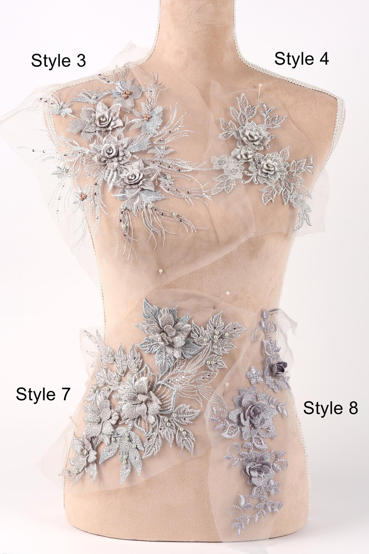 A mannequin with various decorative floral and leaf-like embellishments on its bust and hips, each labeled with a different style number.
