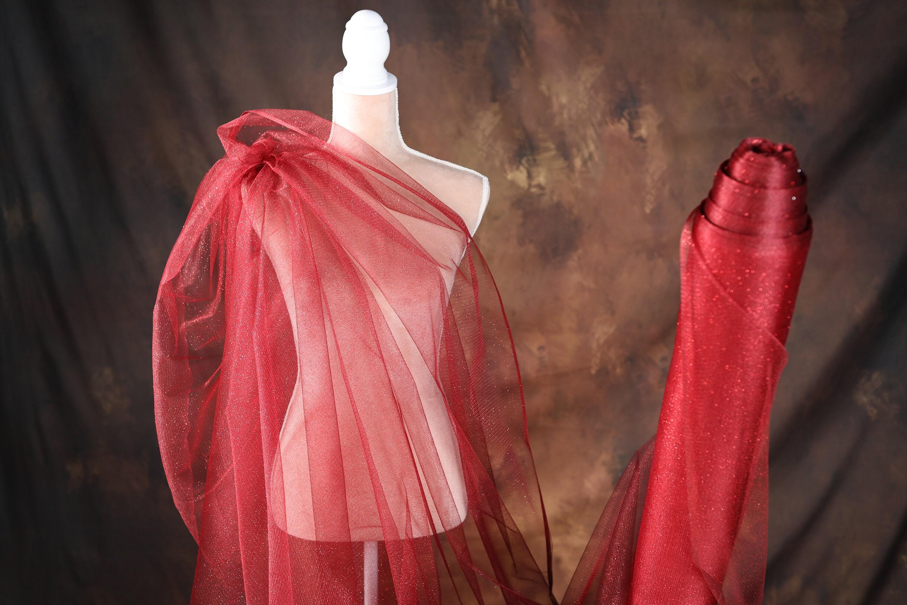 a mannequin dressed in a red dress with a red shawl
