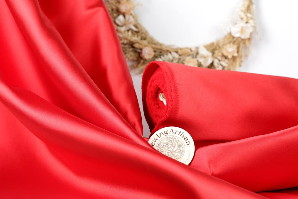 a close-up view of a red fabric, with a small circular object labeled "Sewing artisan" placed on top of it.