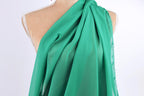 A mannequin wearing a green, flowing scarf.