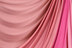 a close-up view of a fabric with a pink and red color gradient, creating a visually appealing and textured appearance.