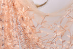 a close-up view of a delicate, peach-colored fabric with a floral pattern. The fabric appears to be made of sheer material, with a delicate, lace-like texture. The floral pattern is composed of small, intricately designed leaves and branches, creating a visually appealing and delicate design.