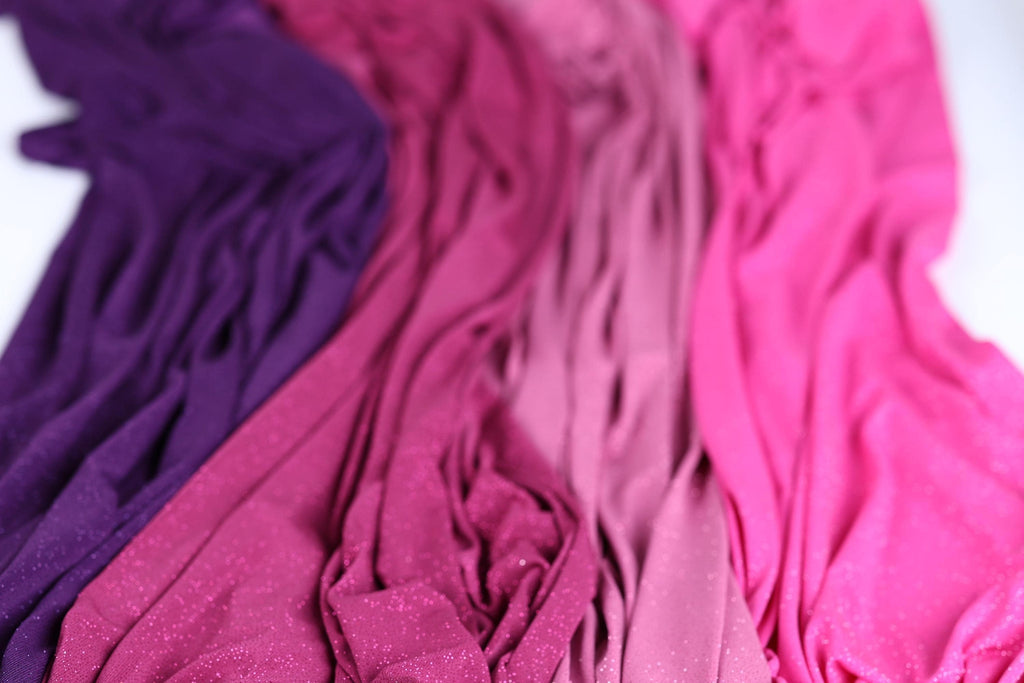 a close-up view of a fabric with a mix of purple and pink colors, creating a visually appealing and textured appearance.