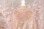 a pink sequin fabric with a floral pattern, displayed on a mannequin.