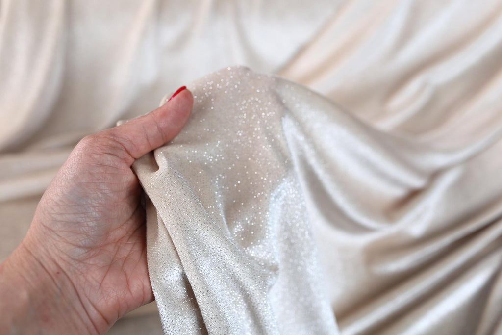 a woman's hand holding a white cloth