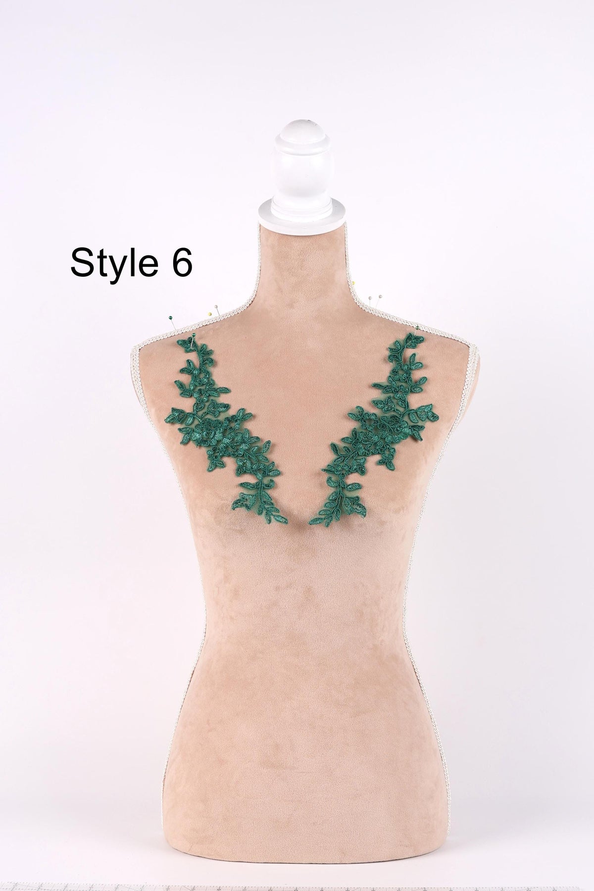 A mannequin with a beige body and green leaf-shaped embroidery on the bust area, labeled as "Style 6".