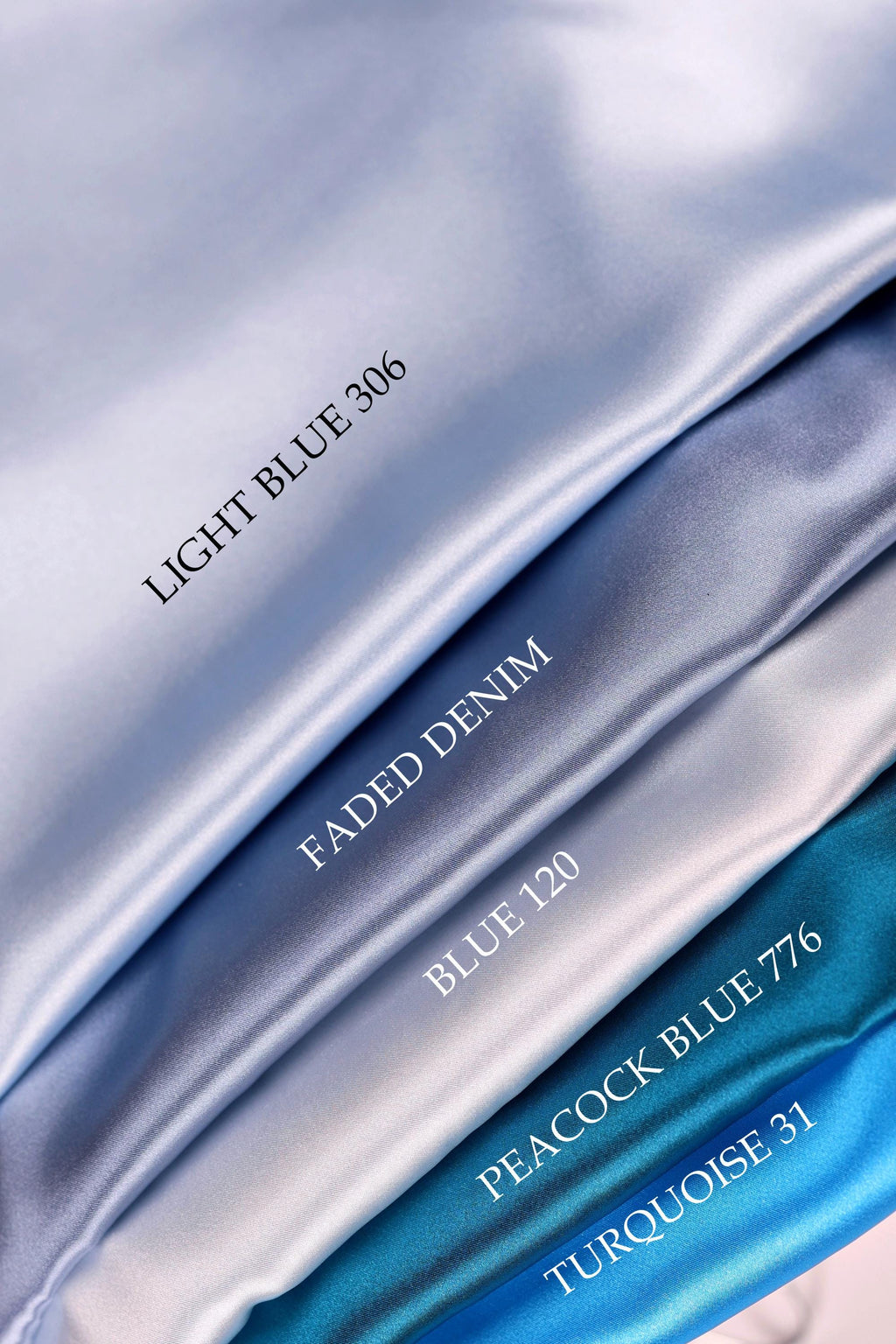 a close-up view of four different colored satin fabrics, each with a label indicating the color and the name of the fabric.