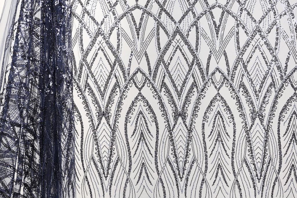 a close-up view of a fabric with a repeating pattern of black and white diamond shapes, creating an intricate and visually striking design.