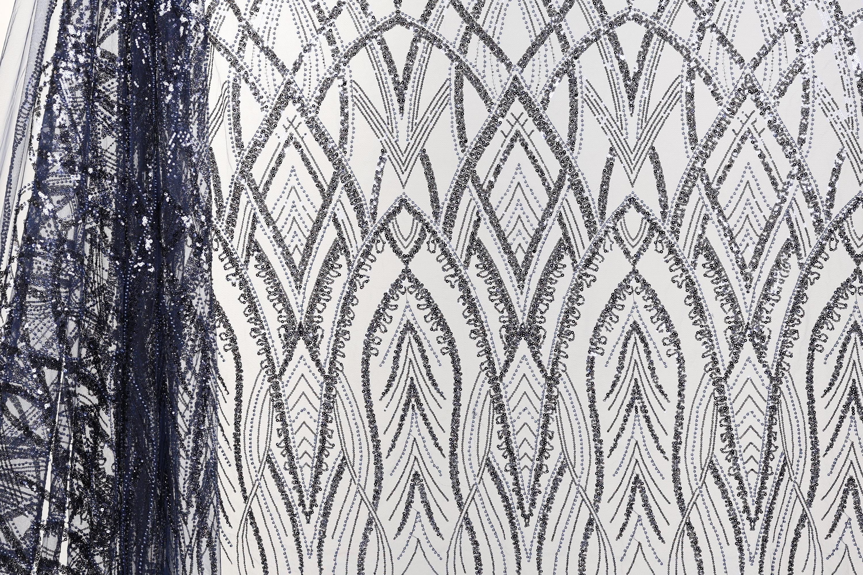 a close-up view of a fabric with a repeating pattern of black and white diamond shapes, creating an intricate and visually striking design.