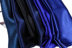 a close-up view of a collection of fabric swatches in various shades of blue, including navy blue, black, and a darker shade of blue.
