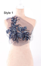 A mannequin wearing a dress with a floral embroidered design on the chest area.