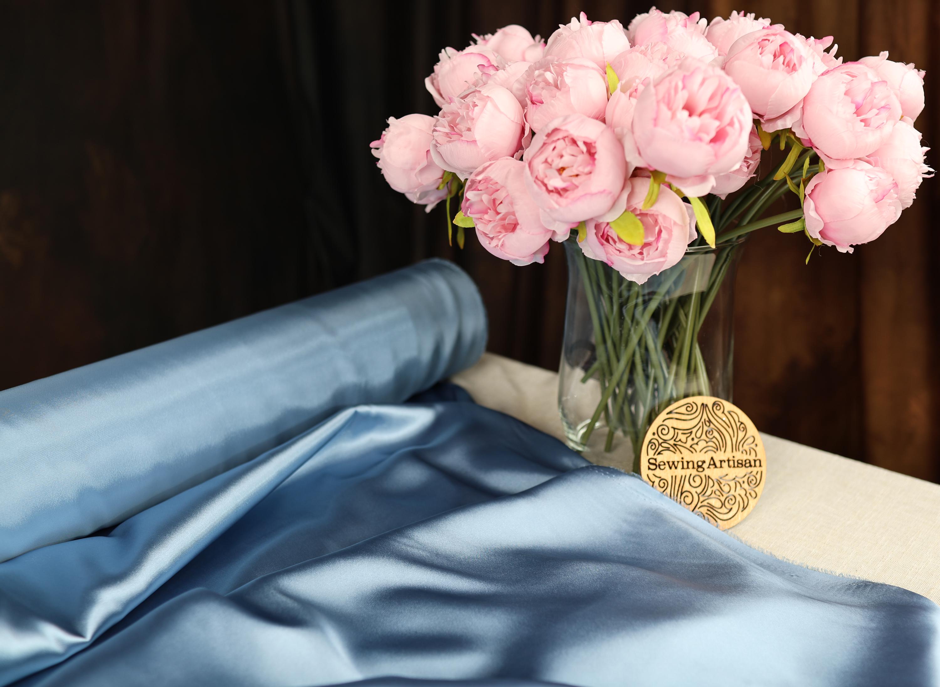 a vase filled with pink flowers on top of a table