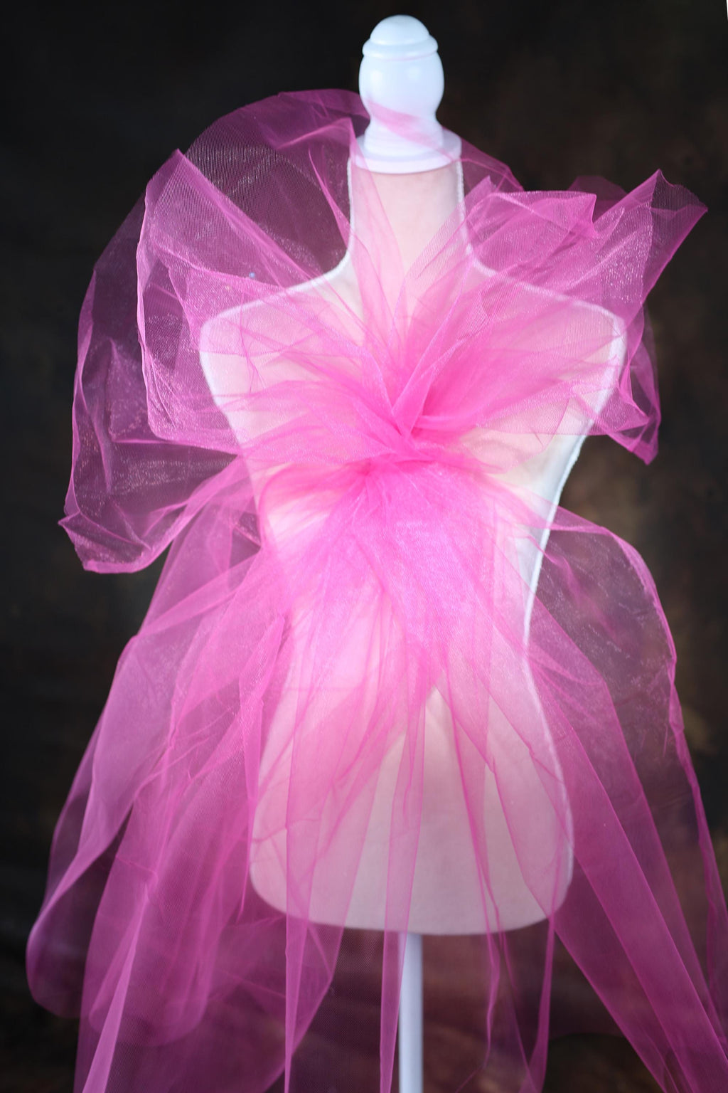 a mannequin with a pink tulle on top of it
