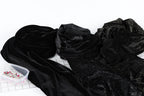 a collection of black velvet fabric with a glittery texture, spread out on a white surface.