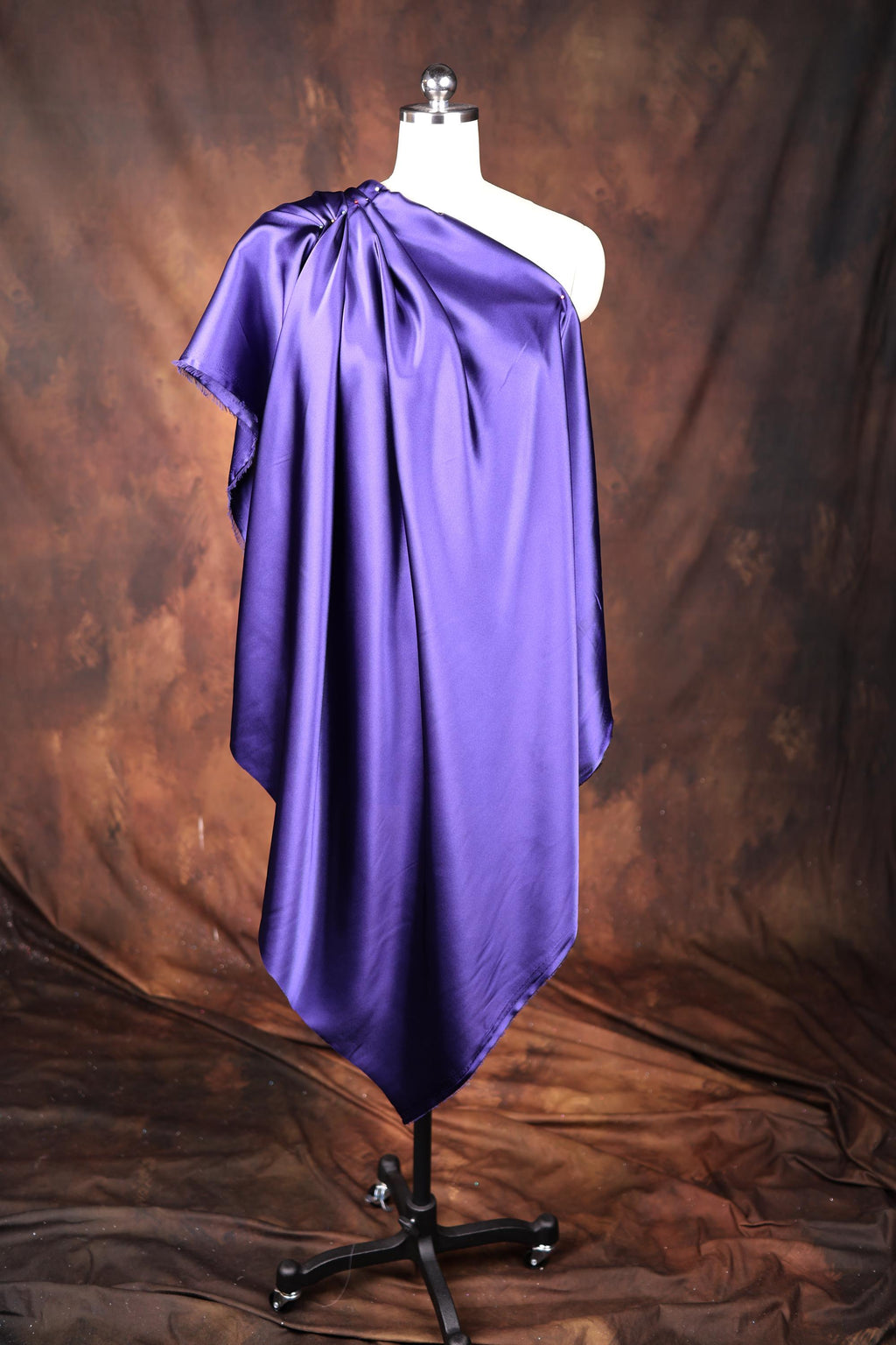 a mannequin dressed in a purple satin dress
