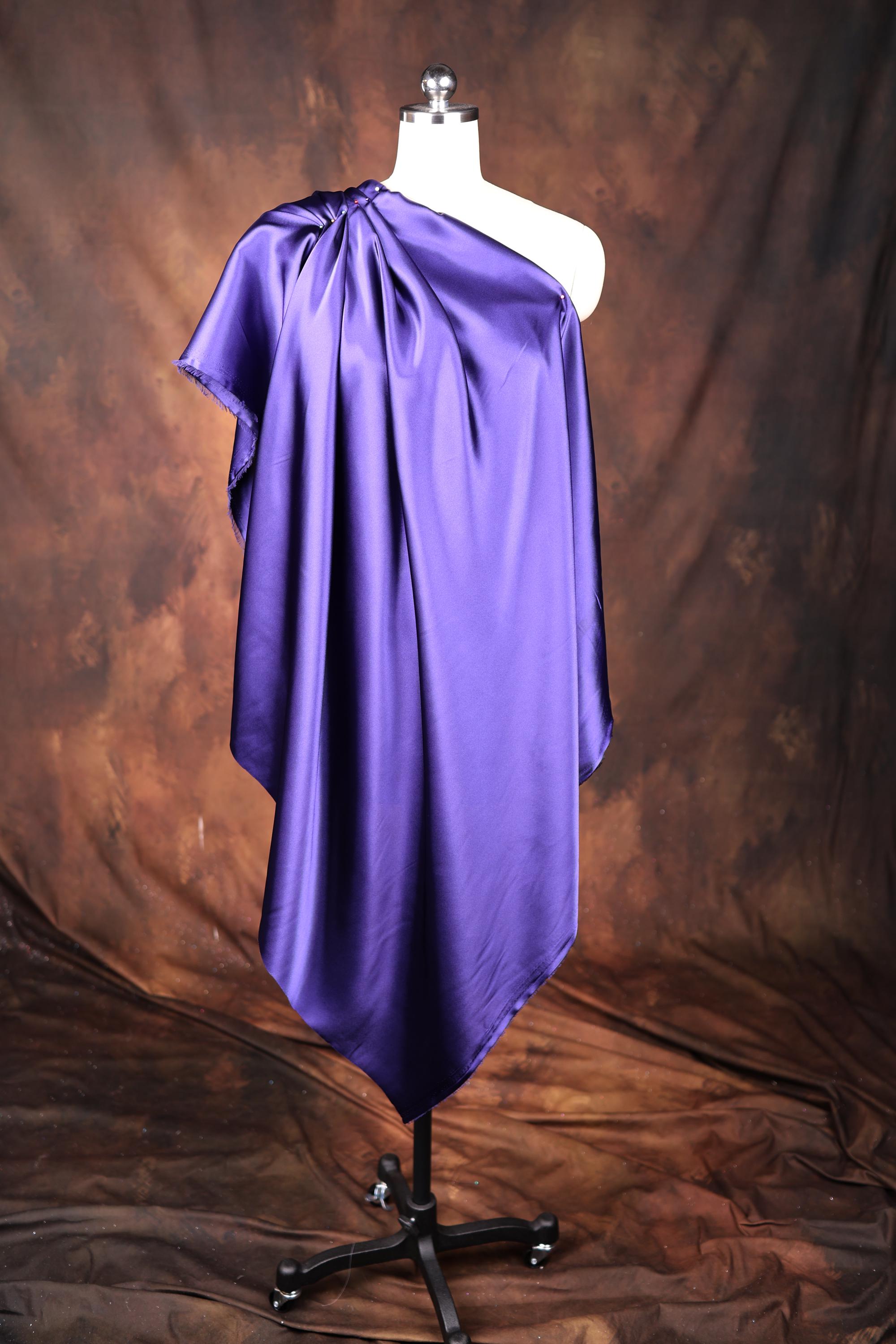 a mannequin dressed in a purple satin dress