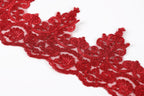 a close-up view of a red, intricately designed lace or embroidery piece.