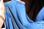 a woman's hand holding a blue cloth
