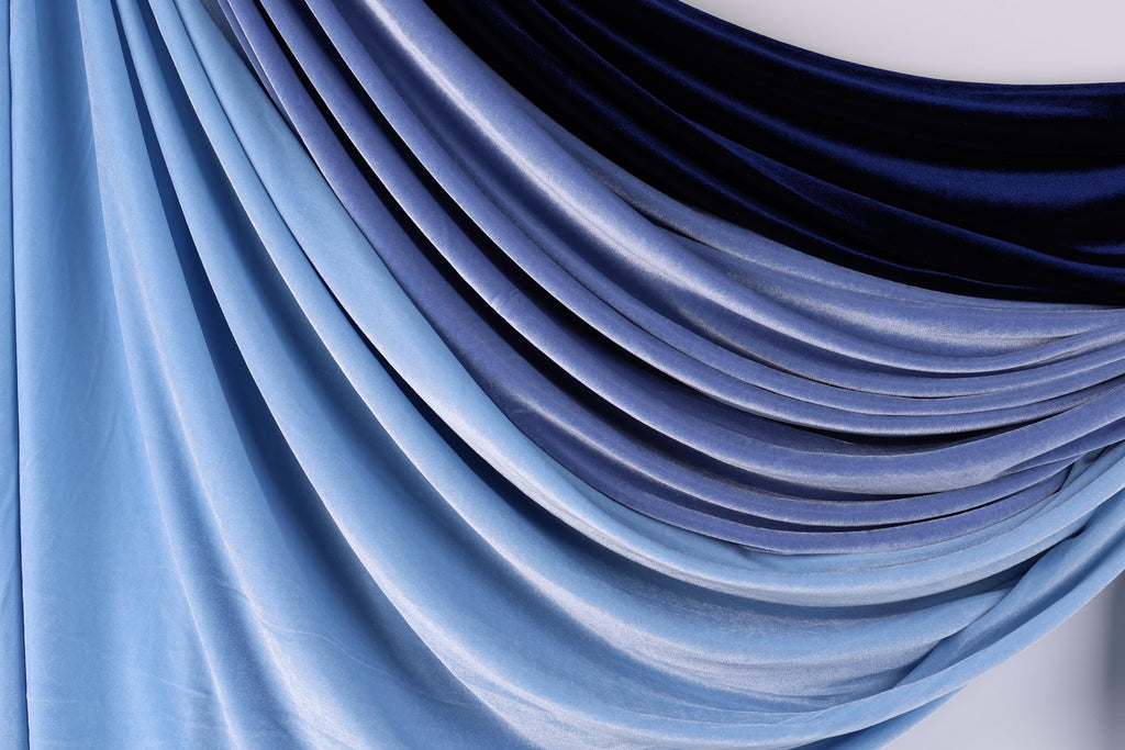 a close-up view of a fabric with a gradient of blue and black colors, creating a visually appealing and textured appearance.