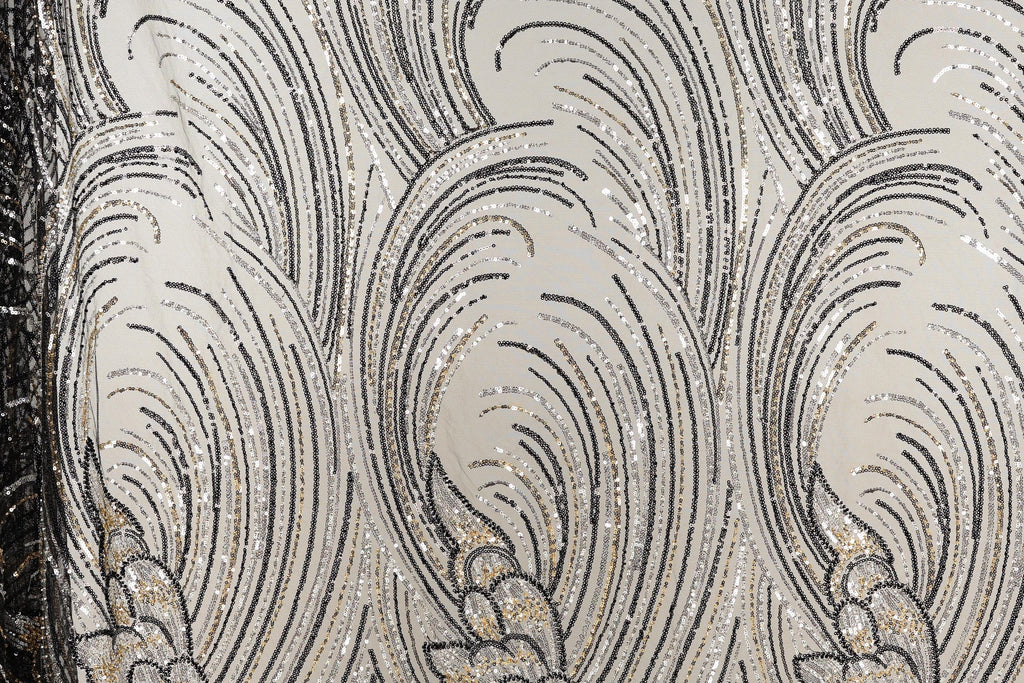 a close-up view of a fabric with a repeating pattern of black and white lines and shapes, creating a visually striking and intricate design.