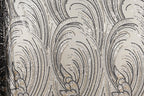 a close-up view of a fabric with a repeating pattern of black and white lines and shapes, creating a visually striking and intricate design.