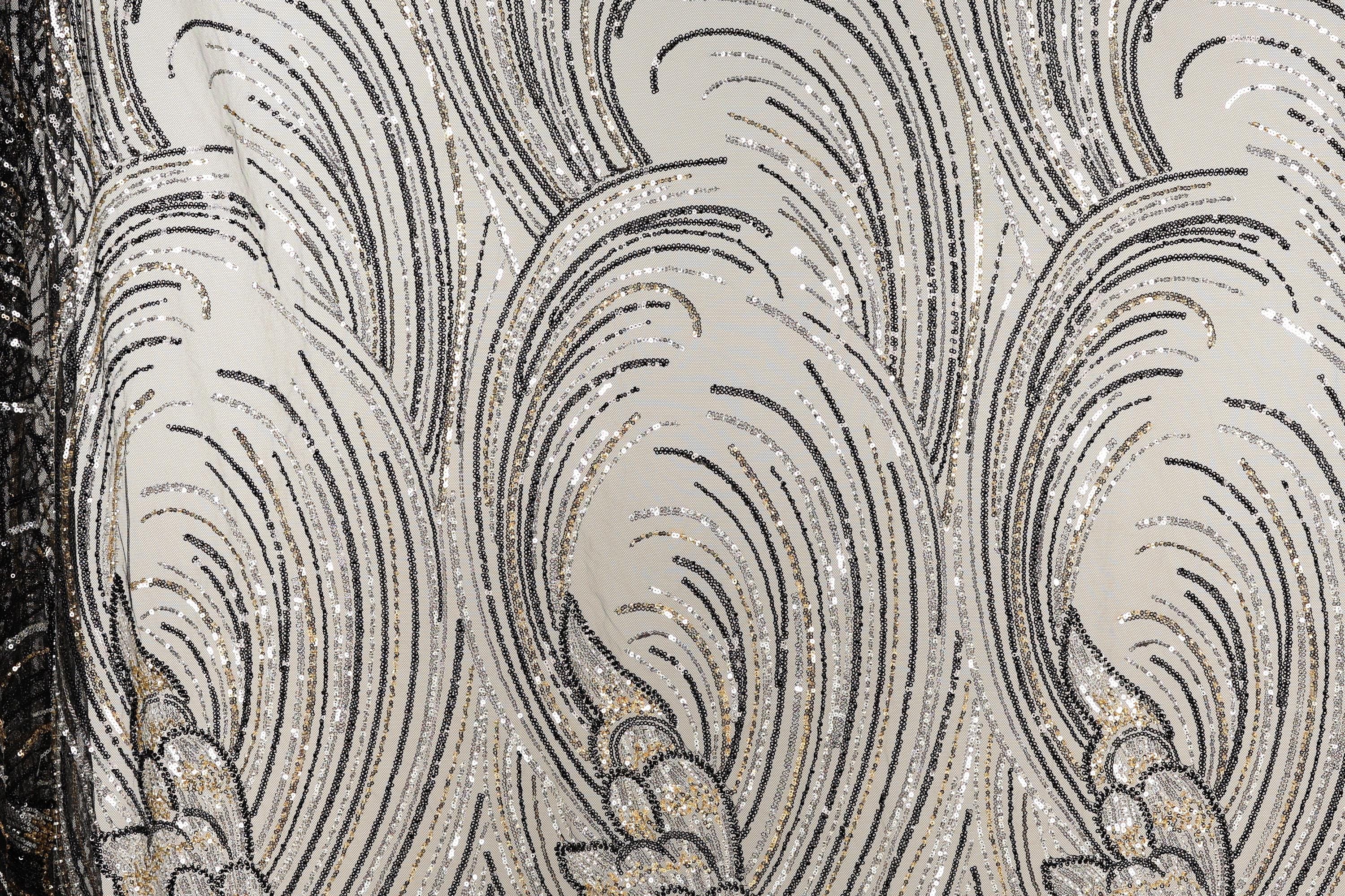 a close-up view of a fabric with a repeating pattern of black and white lines and shapes, creating a visually striking and intricate design.