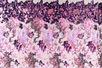 The image is a collage of various images, featuring a pattern of pink and purple sequins or sequin-like textures. The pattern is composed of different shapes and sizes of sequins, creating a visually striking and intricate design.