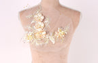 A mannequin with a delicate floral embroidered on its shoulder.