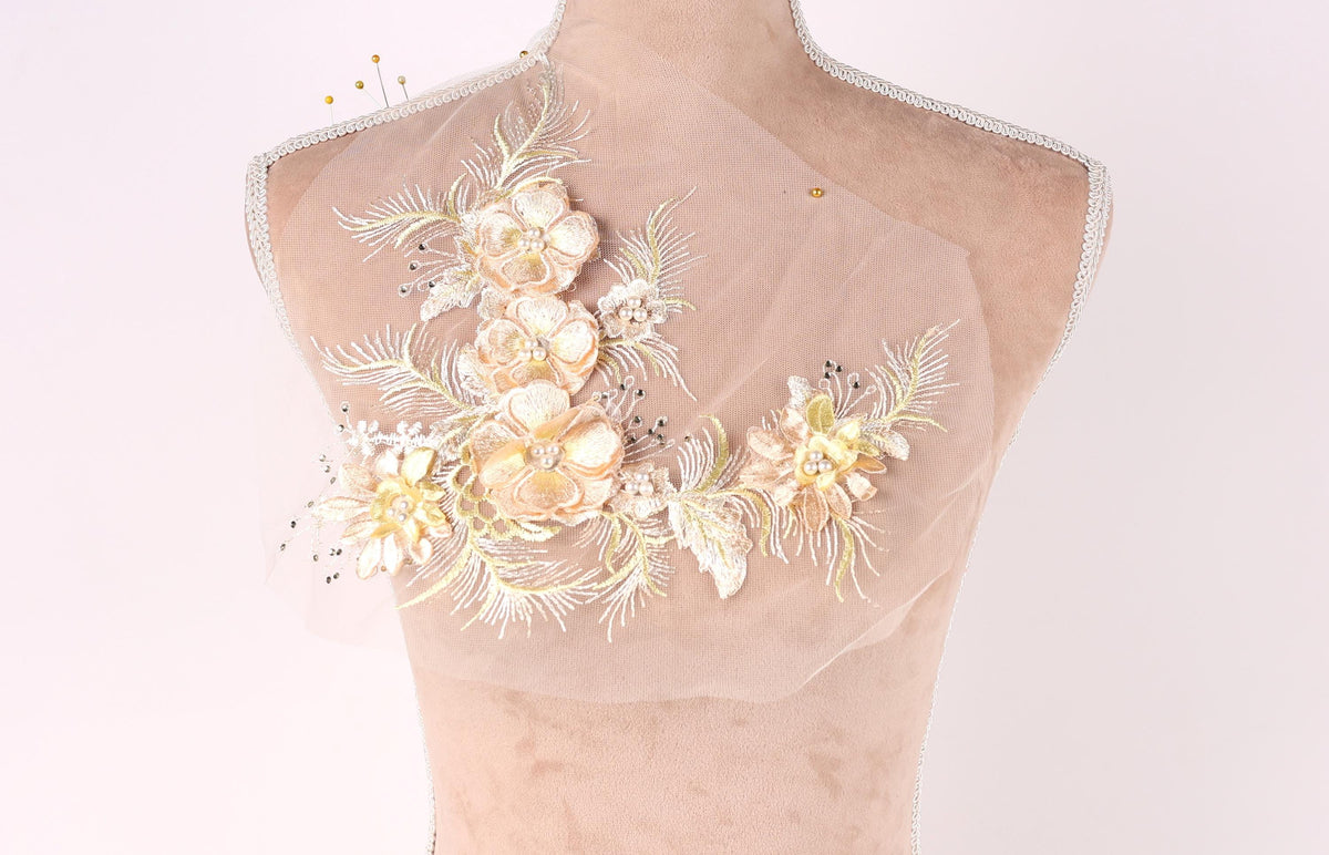 A mannequin with a delicate floral embroidered on its shoulder.