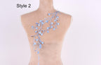 A mannequin with a floral embroidered on its back, featuring blue flowers and branches.