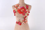 A mannequin wearing a dress with a floral embroidered design on the chest area.