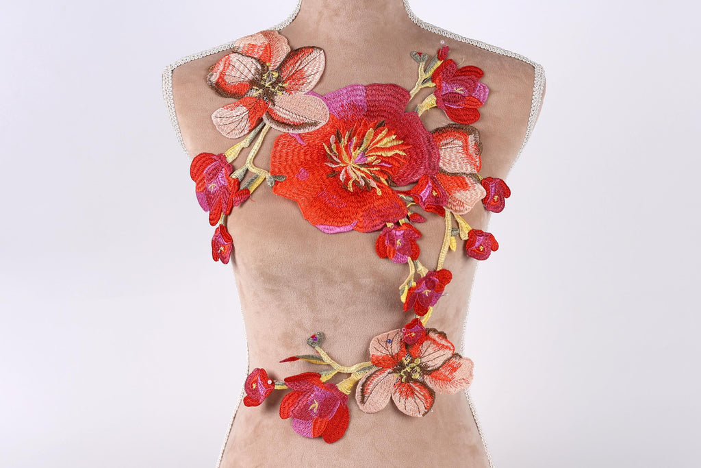 a mannequin with a floral embroidered design on its torso.
