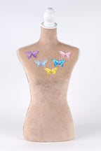 A mannequin bust with colorful butterfly embroidery on the chest area.