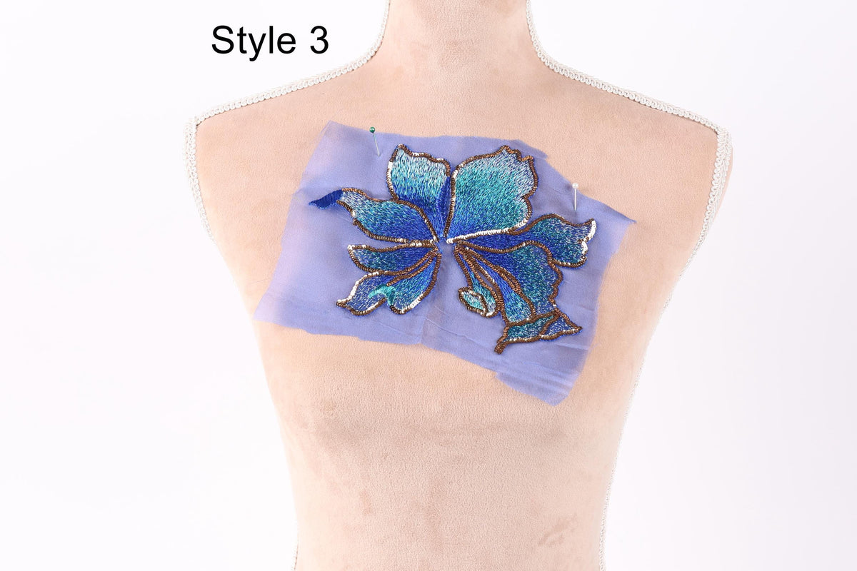 a mannequin with a blue and green floral embroidered on its bust.