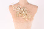 A mannequin bust with a decorative floral embroidery on the back.
