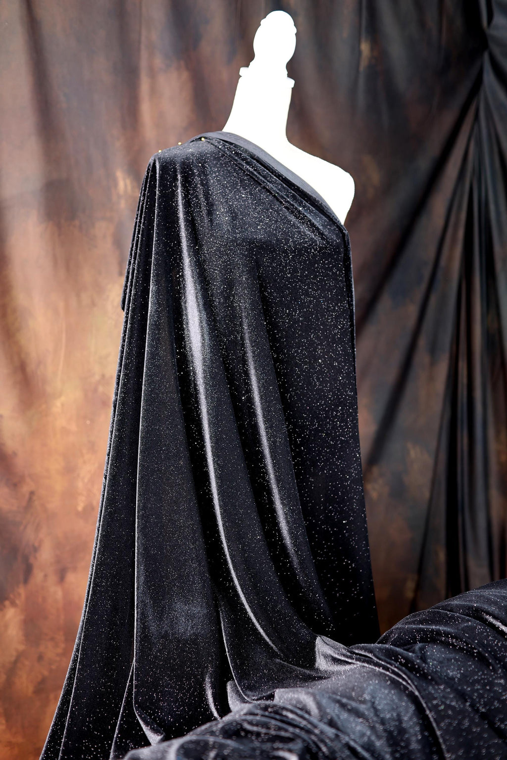 a mannequin dressed in a black cape
