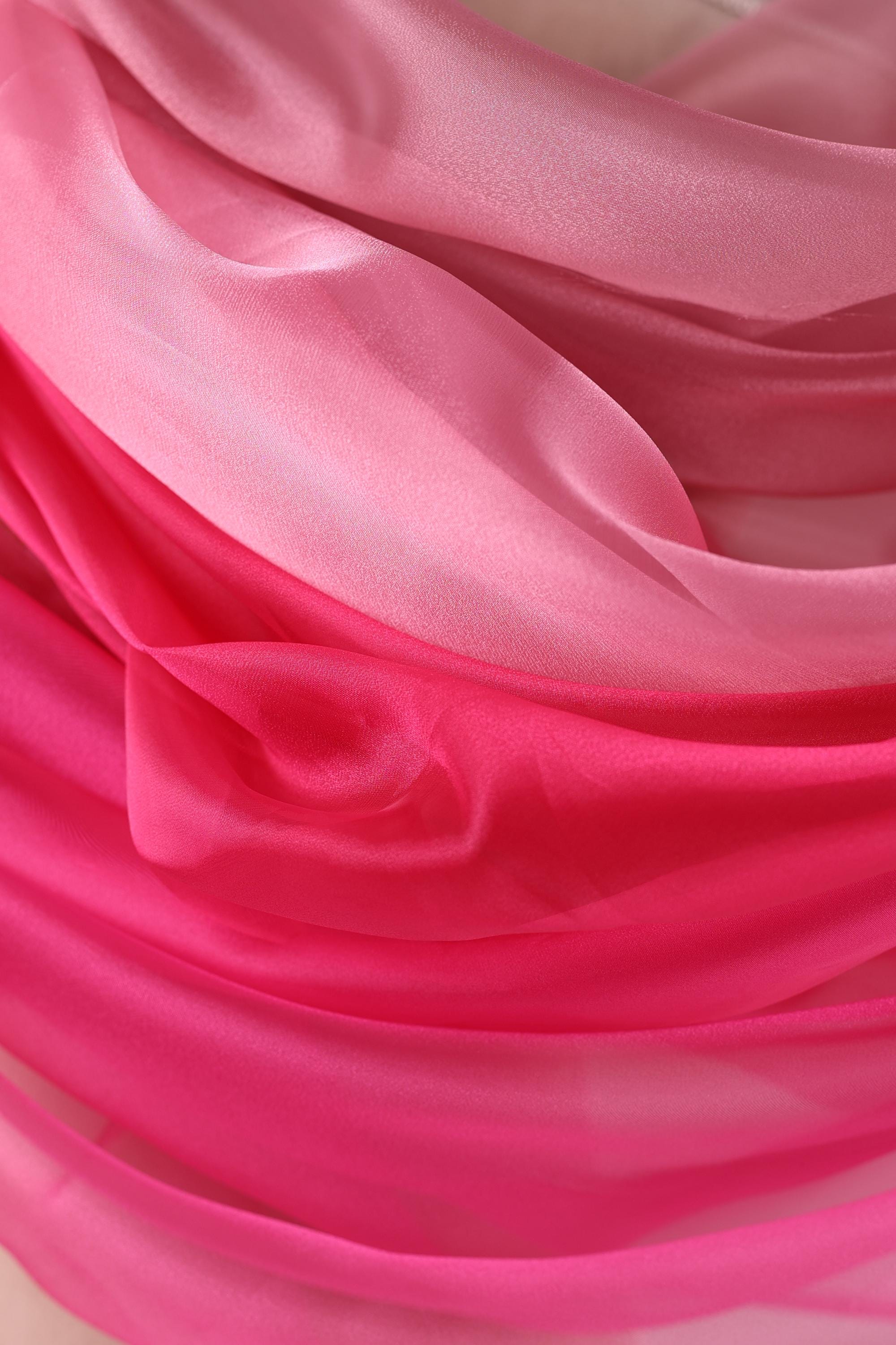 a close-up view of a fabric with a pink and white color gradient, creating a visually appealing and textured appearance.