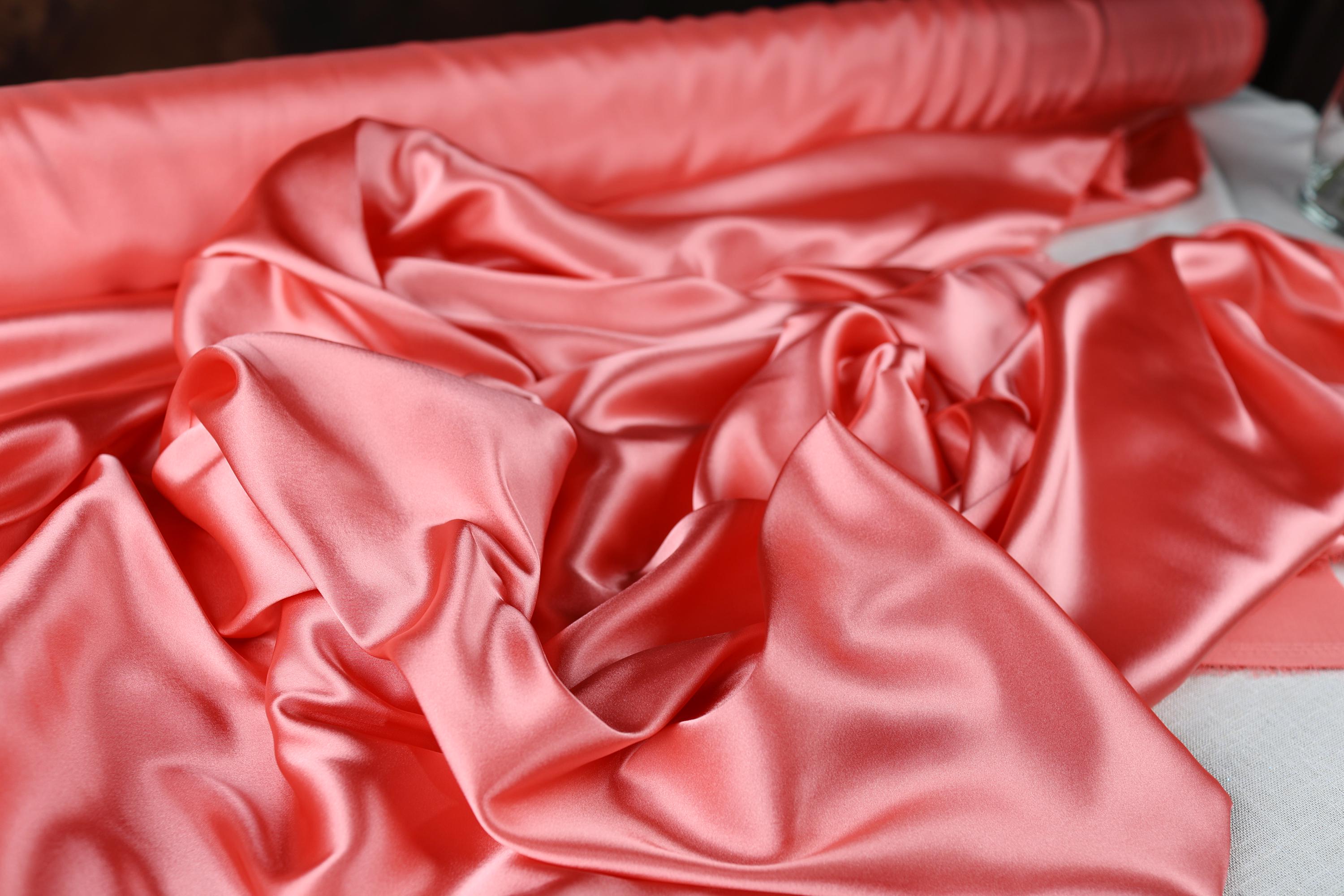 a close up of a pink satin material