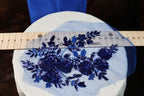a blue piece of cloth with flowers on it next to a ruler