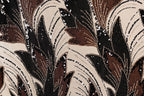 a close-up view of a fabric with a striking pattern of brown and black sequins and beads, creating a visually captivating and intricate design.